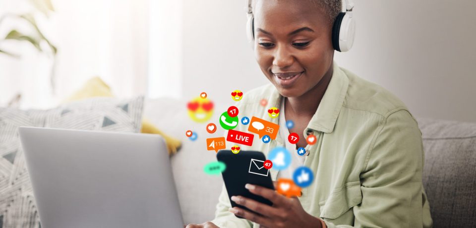 Laptop, social media icon or woman with phone for communication, message or online chat. Headphones, notification emojis or African person streaming music on mobile app on website or network at home.